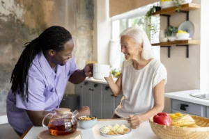 An African social worker assisting a senior woman, offering support and care in a warm and compassionate setting.