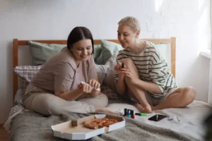 A full shot of a woman receiving a manicure, showcasing relaxation and self-care in a beauty salon setting.